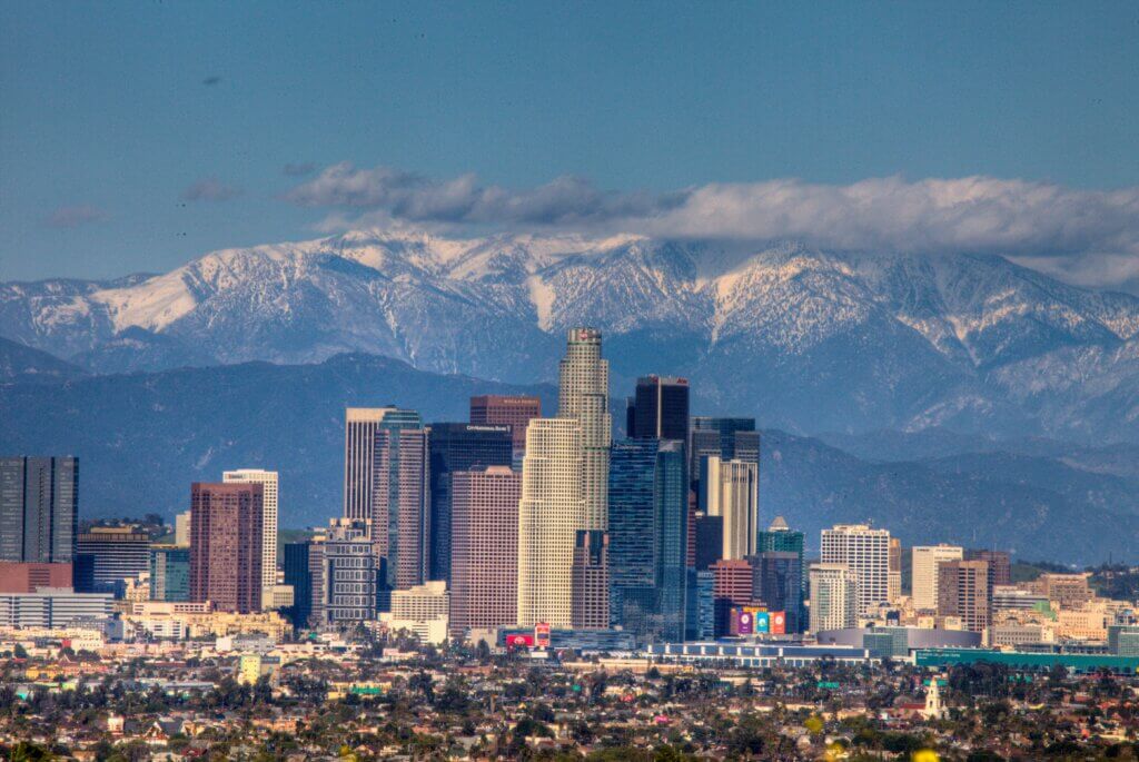 Image of Los Angeles with tall skyscrapers and mountains with snow in the background