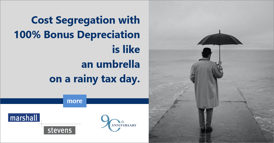 Image of a person standing on a pier with an umbrella and text of Cost Segregation with 100% Bonus Depreciation is like an umbrella on a rainy tax day.